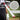 Baseball bat with VukGripz textured handle and close-up of grip texture on a grassy field background.