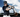 Baseball player performing baseball drills with his baseball bat while in full baseball uniform on a party cloudy day
