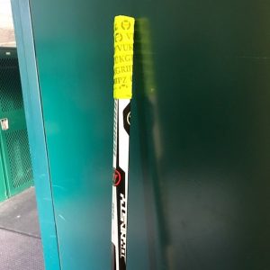 Neon Green Best Hockey Stick Tape on a Hockey Stick- best hockey stick tape available for use on your hockey stick. Hockey Stick Tape improves grip on your hockey stick.