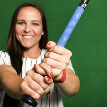 Vuk athlete holding a wooden softball bat wrapped in VukGrip softball bat grip tape